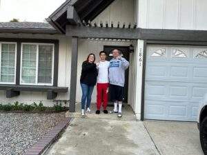 Three people standing in front of a real estate house in Simi Valley.