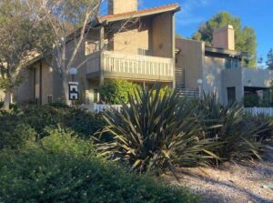 A picturesque apartment complex nestled in the beautiful landscape of Simi Valley, adorned with a lush array of trees and shrubs.