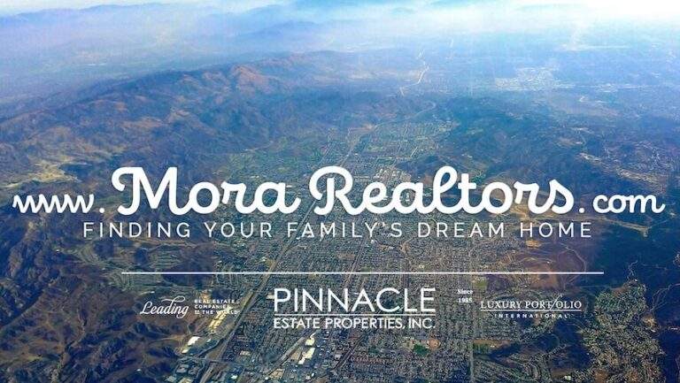 An aerial view of a city with the words mora realtors com ending your family's dream home in real estate simi valley.