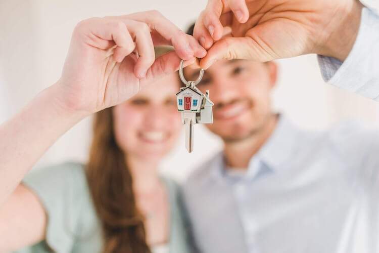 A couple in Simi Valley holding a key to their new real estate.